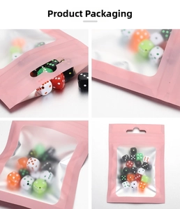 Detailed view of colorful dice sets in pink matte resealable bags with clear window