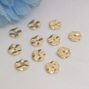 Set of 10 irregular wave-shaped 14K gold filled spacer beads on white fabric