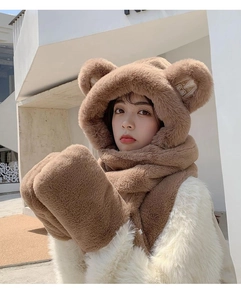 Detail showing plush teddy bear ear hood with letter M embroidery and soft faux fur texture