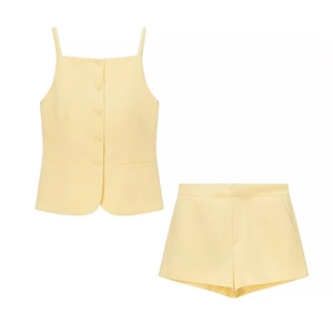 Women's yellow two-piece set featuring a buttoned tank top and matching tailored shorts