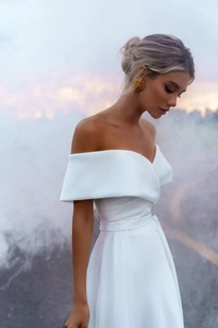 Close-up of off-the-shoulder satin wedding dress with elegant V-neckline detail