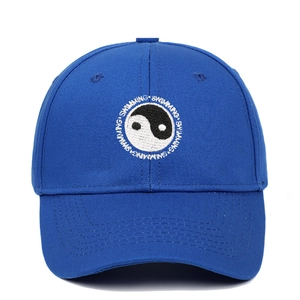 Macro detail of Tai Chi embroidery and Swimming text on blue cotton baseball cap