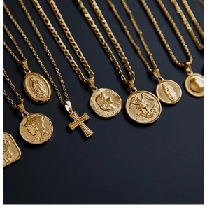 Detailed view of vintage gold-plated titanium steel necklaces with religious and coin charms