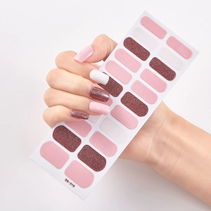 Close-up of SS-019 self-adhesive nail stickers featuring pink and red glitter designs