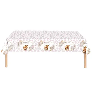 Macro detail of the Holy Cow baby shower tablecloth featuring floral highland cow designs