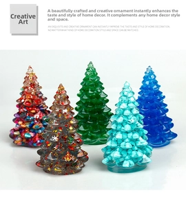 Detailed view of five mini resin Christmas trees with colorful glitter and stone fills