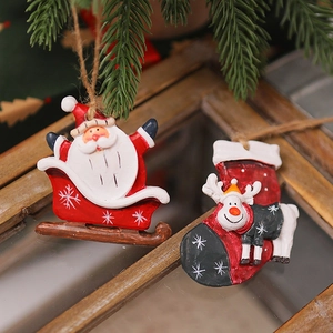 Detailed view of resin Santa and reindeer ornaments hanging on a Christmas tree