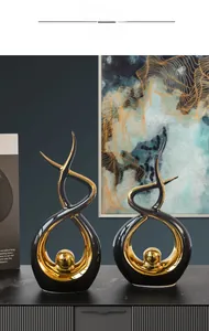 Abstract black and gold ceramic statues on a cabinet for modern home office decor
