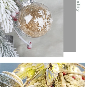 Close-up of 8cm clear Christmas ball filled with gold glitter and white snowflakes