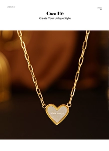 Macro shot of 14K gold plated heart pendant with NEVER FORGET engraved lettering