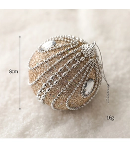Close-up of 8cm gold Christmas ball with silver beads and glitter details
