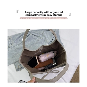 Interior view of beige leather tote showing spacious capacity and organized pockets