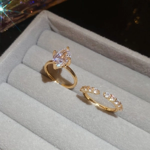 Detailed macro of gold plated oval zircon ring set in a grey velvet jewelry box