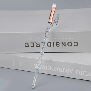 Close-up of angled eyebrow brush with glitter crystal handle and rose gold ferrule