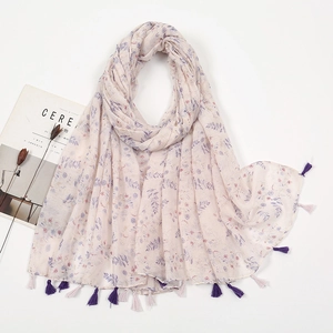 Detailed view of floral pattern and purple tassels on a lightweight cotton-linen scarf