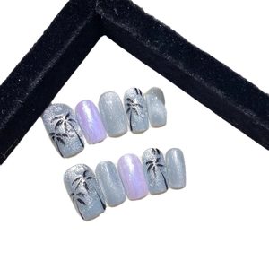 Handmade aurora cat eye press-on nails with purple marble effect and palm tree art