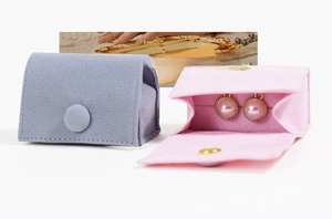 Detail of velvet jewelry pouch showing soft microfiber texture and snap button closure