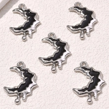 Detailed view of crescent moon charms with black enamel and silver alloy frames for DIY jewelry
