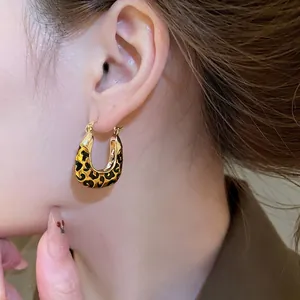 Vintage leopard print square pendant hoop earrings on model with gold finish