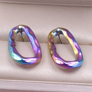 Macro detail of wavy irregular oval earrings with iridescent rainbow plating finish