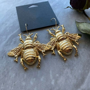 Vintage gold bumblebee drop earrings featuring detailed wings and a realistic insect design