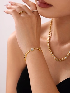 Detail of 18K gold-plated stainless steel chain bracelet with white cubic zirconia accents