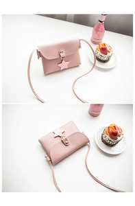 Detailed view of mini pink PU leather crossbody bag with star pendant and metal snap