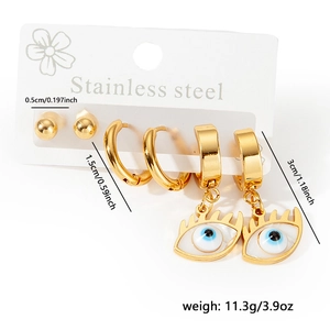 Detailed view of three-piece gold stainless steel earring set with evil eye charm