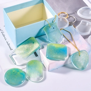 DIY silicone mold set for heart and round resin pendants with blue glitter and keychains