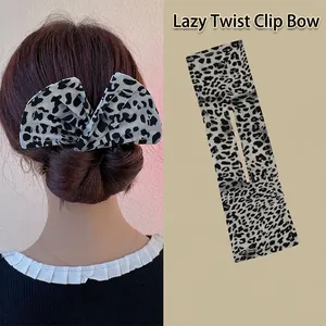 Detail of leopard print fabric hair bun maker showing tool structure and styling effect