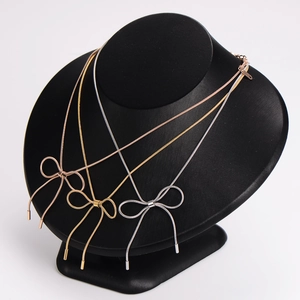 Elegant stainless steel bow pendant necklaces in gold, silver, and rose gold finishes