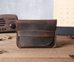 Detail of dark brown crazy horse leather card holder with retro handmade stitching
