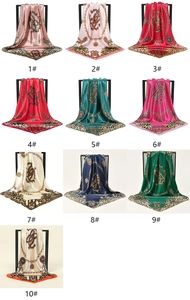 Detail view of square leopard print silk scarves with gold chains in ten vibrant color options