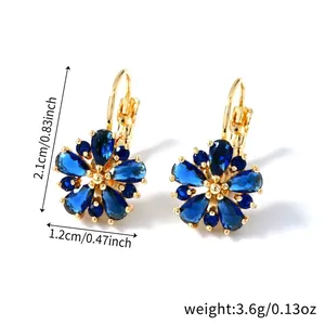 Detail showing dimensions of flower earrings with blue teardrop crystals and gold finish