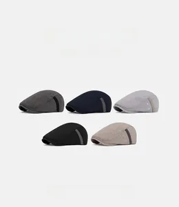 Flat lay display of five vintage newsboy caps in charcoal, navy, grey, black and khaki