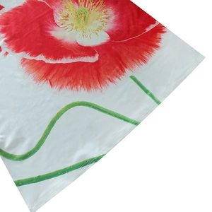 Close-up of vibrant red poppy floral print on white sleeveless summer A-line dress