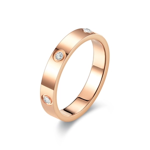 Close-up of rose gold titanium ring with three inlaid crystals and polished finish