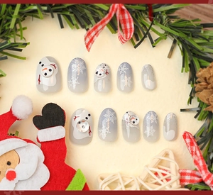 Close-up of Christmas press-on nails with 3D snowman and snowflake embossing