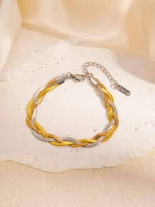 Detail of two-tone braided stainless steel necklace featuring gold and silver weaving