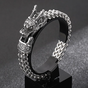 Detailed macro view of retro silver stainless steel dragon head with vintage scale chain