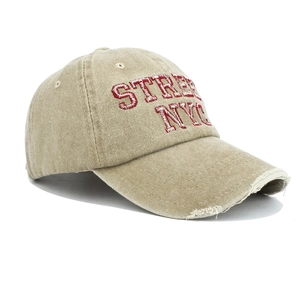 Detail of red STREET NYC embroidery and distressed brim on washed cotton baseball cap