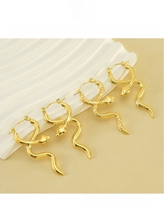Detailed view of 18k gold plated titanium steel snake hoop earrings with scale texture