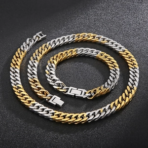 Close-up of two-tone gold and silver Cuban link chain necklace and bracelet set
