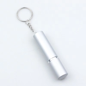 Close-up of a silver portable metal container with a keychain on a white background