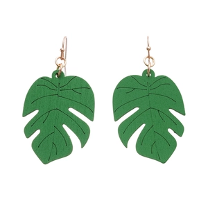 Green tropical monstera leaf wooden earrings with golden metal hooks on white background