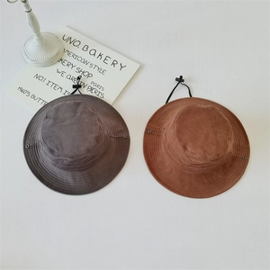 Detail view of dark grey and brown red outdoor sun hats with adjustable drawstrings