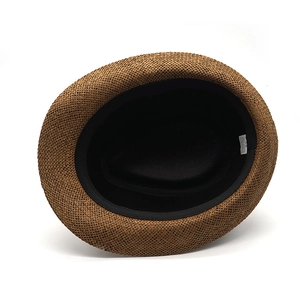 Detail view of the breathable paper straw interior with a black sweatband and size label