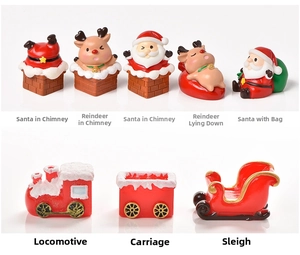Detail view of miniature Christmas resin figurines including Santa and a red locomotive