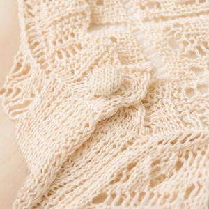 Chic cream openwork mesh knit cardigan with elegant matching knitted button detail