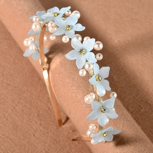 Detail of light blue floral headband with white pearls and crystals on gold metal wire